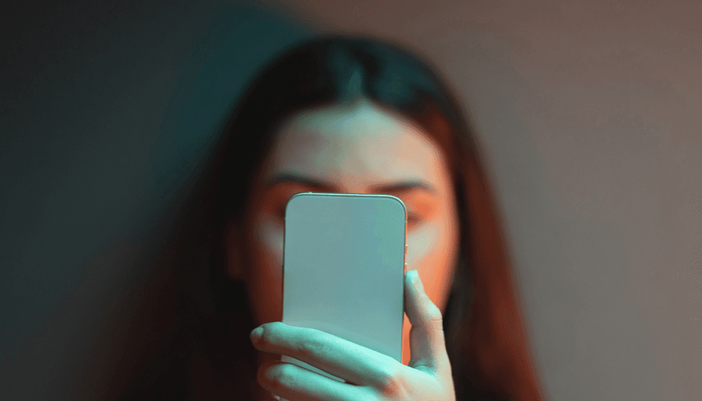 A person holding a phone, about to answer a call.